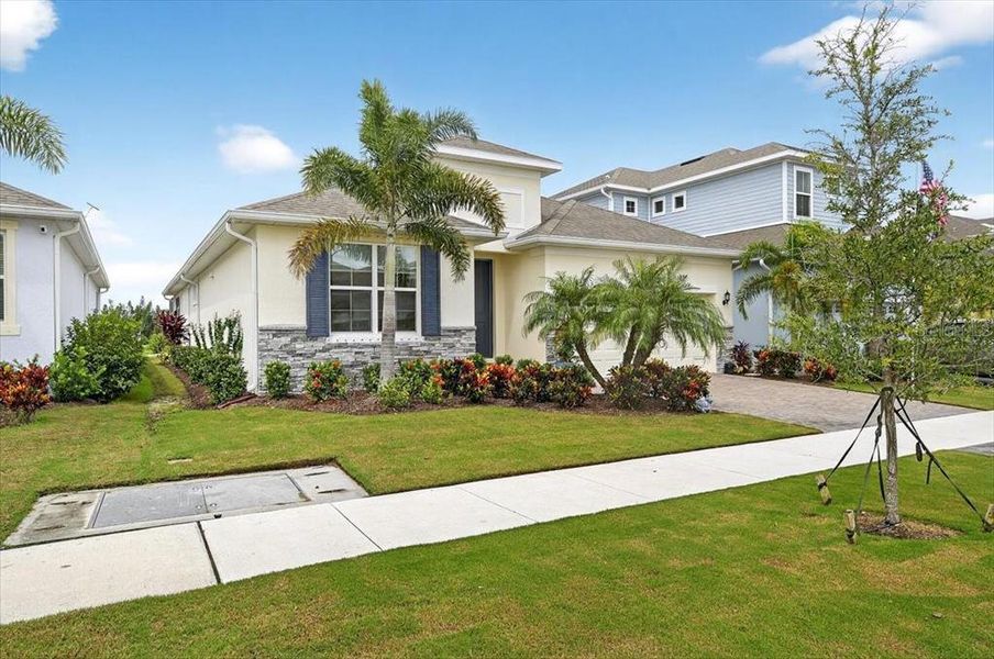 Front exterior of a new home in Marisol Pointe at MiraBay Florida Series, Apollo Beach, FL, highlighting curb appeal (Image 22).