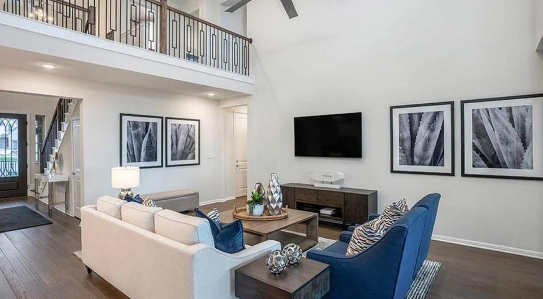 Living area with dark wood finished floors and a high ceiling