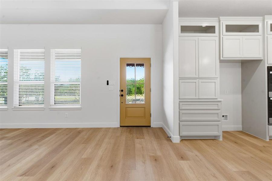 Entryway with light wood-type flooring and baseboards Entryway with light wood-type flooring and baseboards