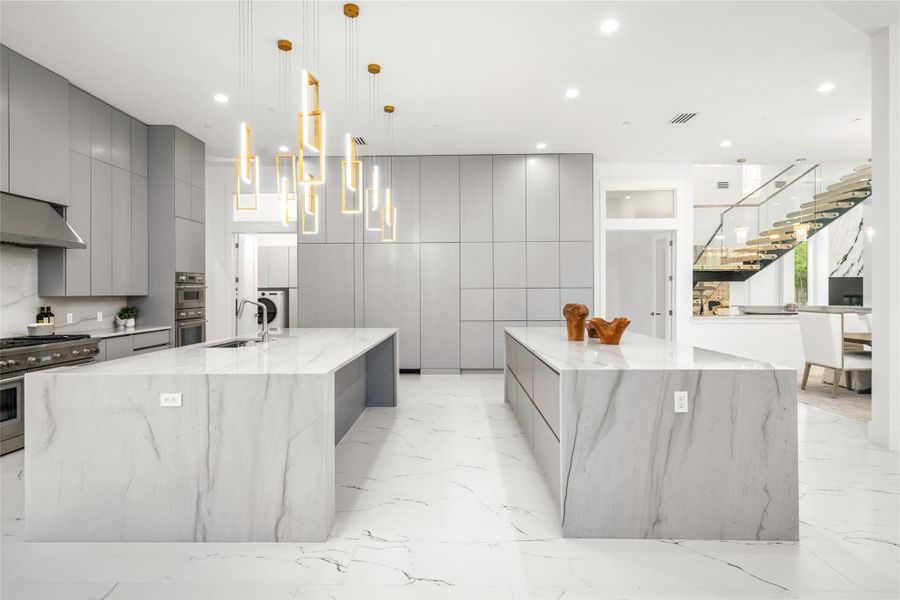 The kitchen is thoughtfully outfitted with a full-size, integrated Thermador refrigerator and freezer, a professional-grade 48-inch Thermador gas range with griddle, and a total of four ovens to accommodate even the most ambitious culinary endeavors. A sleek pot filler, hidden appliance pantry, and an expansive walk-in pantry—complete with abundant storage and a secondary sink. The kitchen is thoughtfully outfitted with a full-size, integrated Thermador refrigerator and freezer, a professional-grade 48-inch Thermador gas range with griddle, and a total of four ovens to accommodate even the most ambitious culinary endeavors. A sleek pot filler, hidden appliance pantry, and an expansive walk-in pantry—complete with abundant storage and a secondary sink.