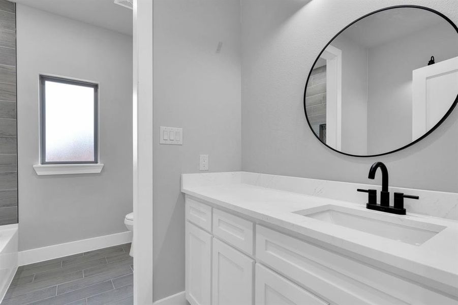 Full bathroom featuring vanity, wood finish floors, and shower / bath combination