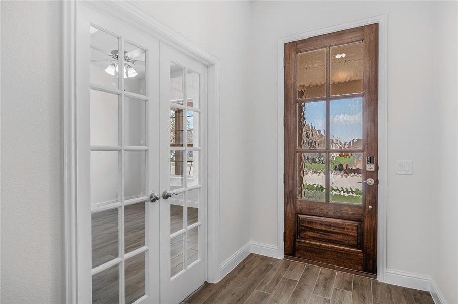 Entryway featuring wood finish floors, ceiling fan, french doors, and healthy amount of natural light Entryway featuring wood finish floors, ceiling fan, french doors, and healthy amount of natural light