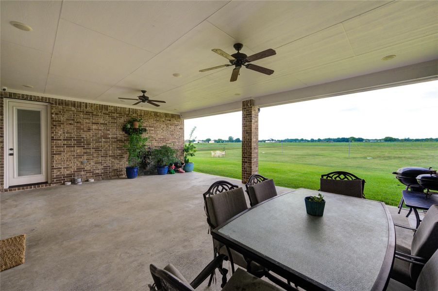 Spacious covered patio overlooking the backyard, ideal for relaxing or hosting gatherings.