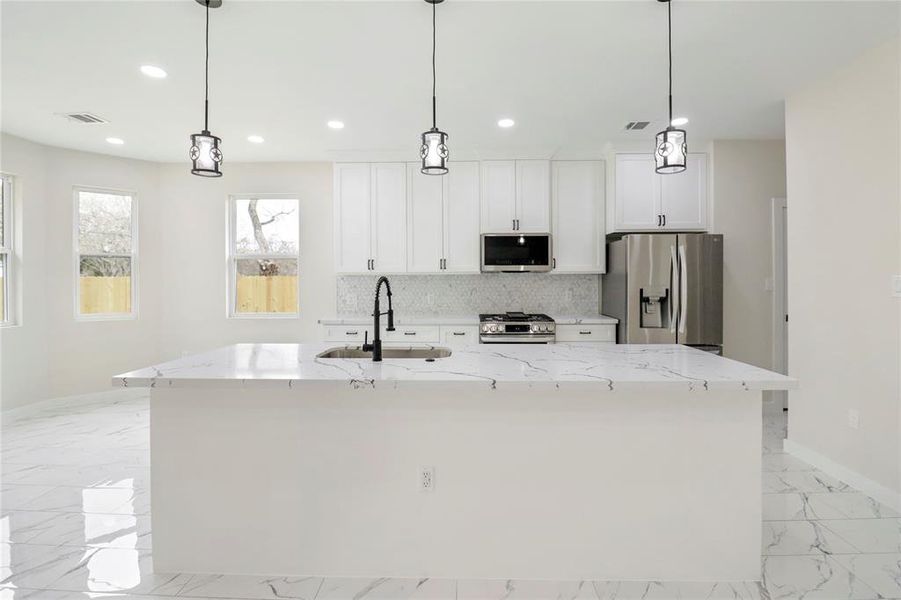 Kitchen island with star accent hanging lights.