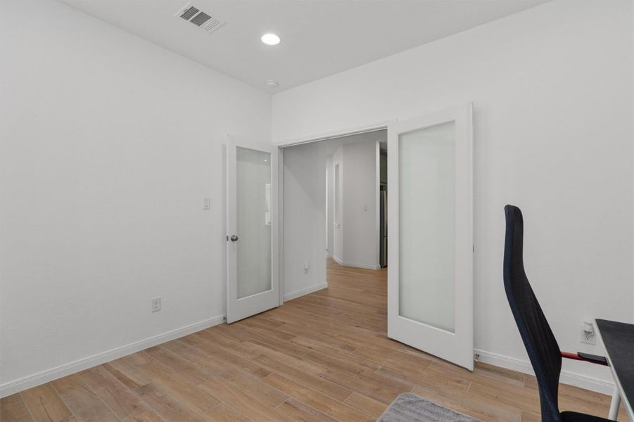 Unfurnished office featuring light wood-style floors and recessed lighting