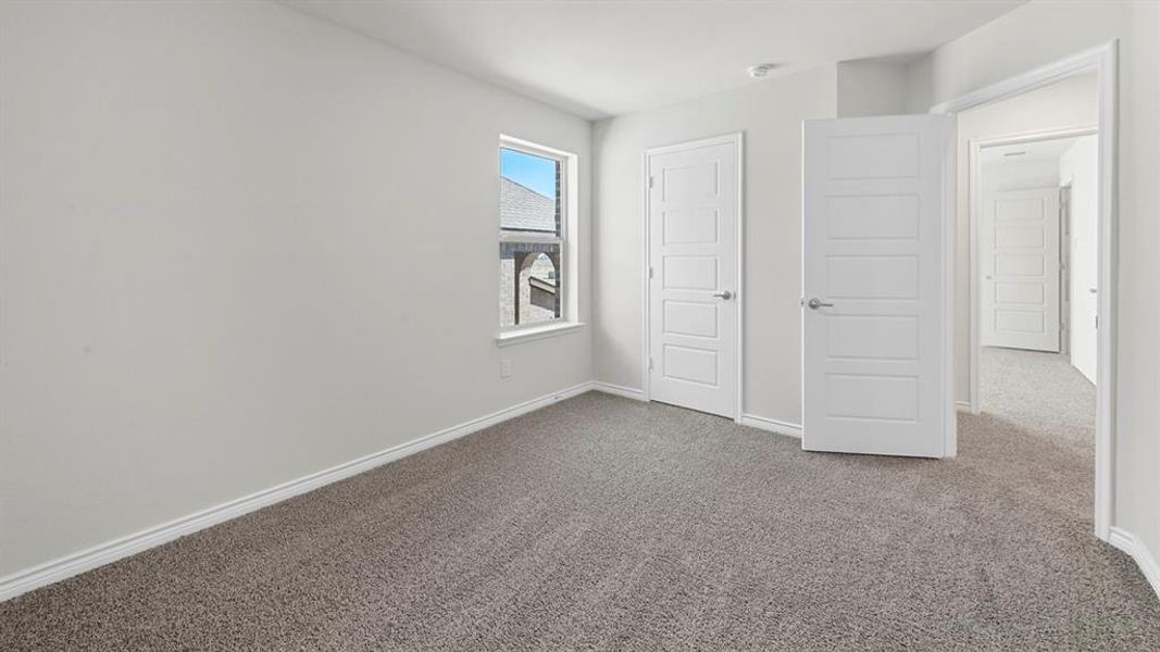 Unfurnished bedroom featuring carpet floors and a closet