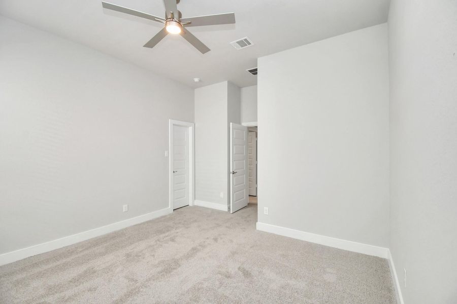 Secondary bedroom features plush carpeting, large windows that let in plenty of natural light, bright paint, and spacious closets. Secondary bedroom features plush carpeting, large windows that let in plenty of natural light, bright paint, and spacious closets.