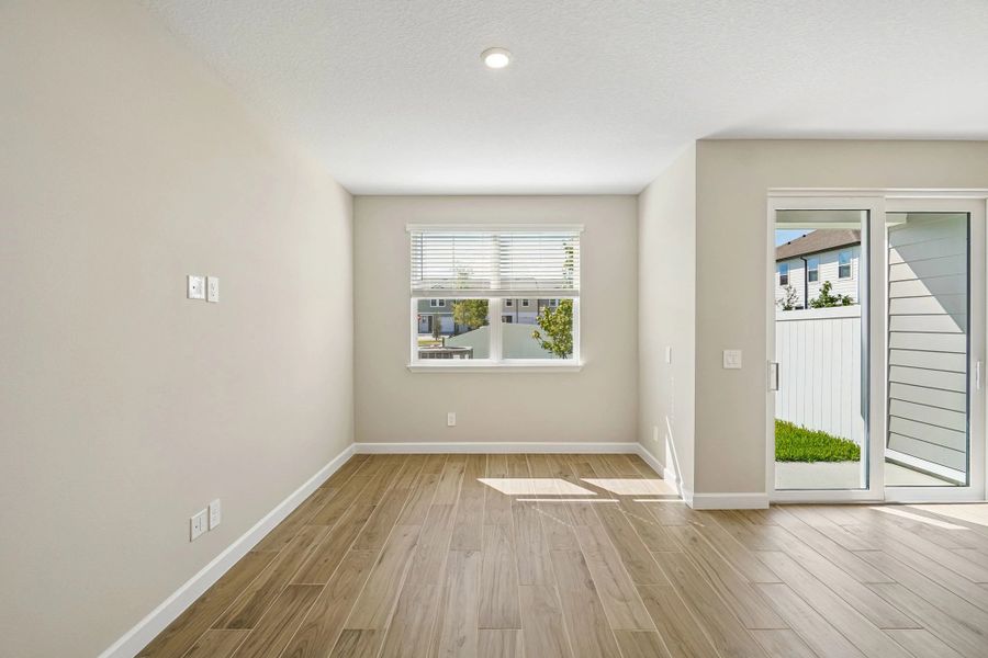Spacious family room with great lighting coming from the double windows