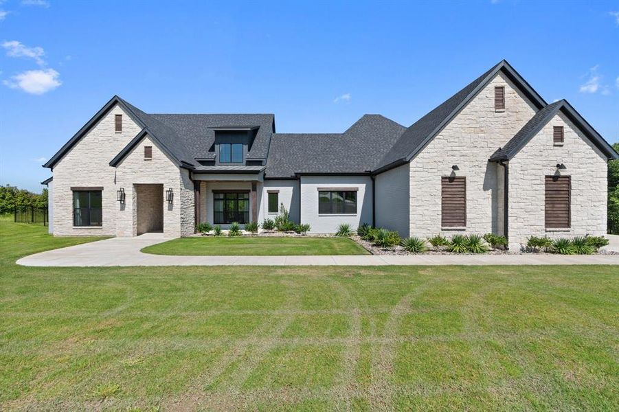 French country style house with a front lawn