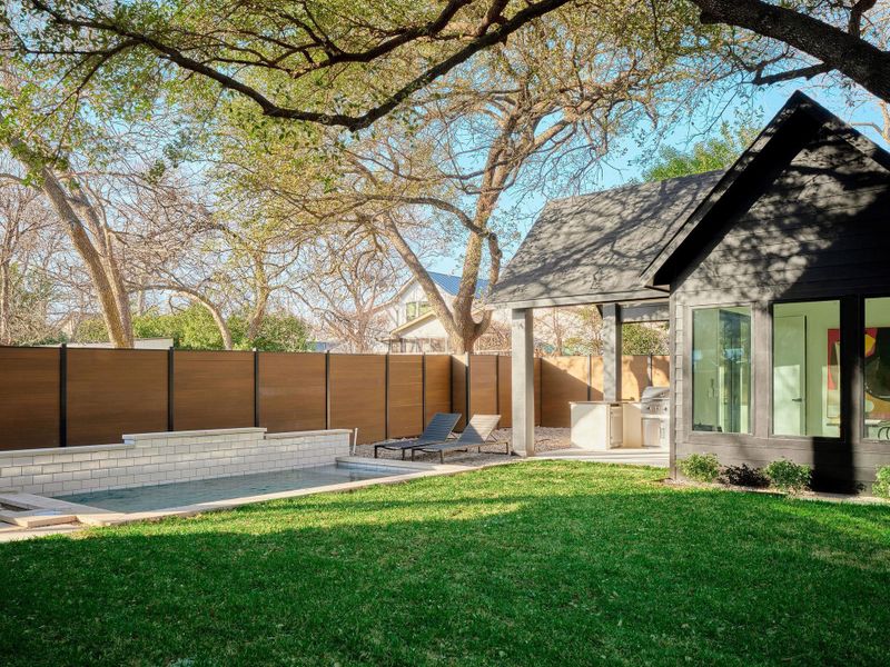 Fenced backyard with a patio