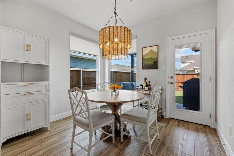 Dining area with light wood-style floors and baseboards