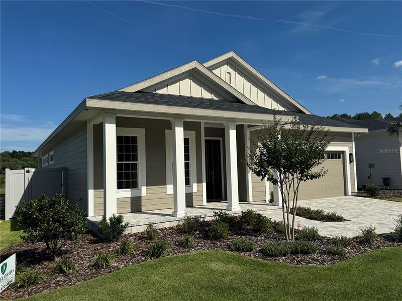 Front exterior of a new home in Laureate Village, Newberry, FL, highlighting curb appeal (Image 2). Front exterior of a new home in Laureate Village, Newberry, FL, highlighting curb appeal (Image 2).