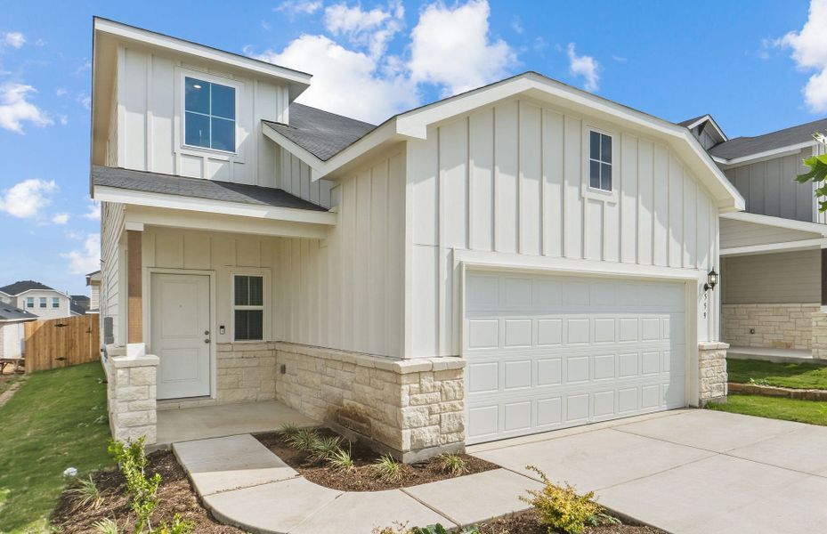 Front exterior of a new home in Sunfield, Buda, TX, highlighting curb appeal (Image 1). Front exterior of a new home in Sunfield, Buda, TX, highlighting curb appeal (Image 1).