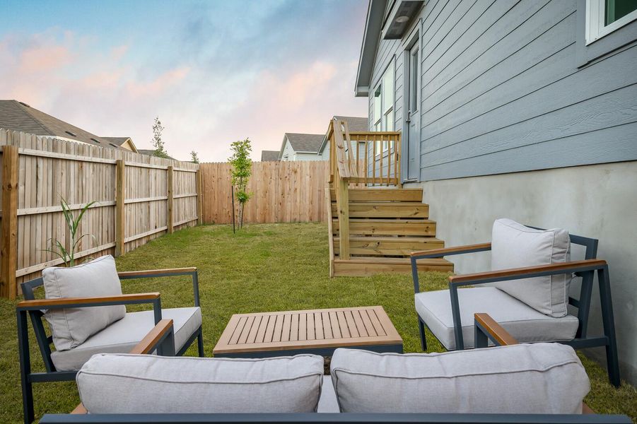 Yard at dusk with an outdoor living space and a fenced backyard Yard at dusk with an outdoor living space and a fenced backyard