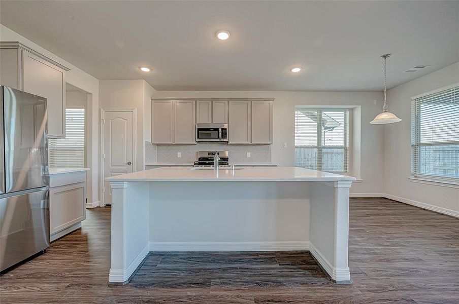 Light & bright with a neutral color palette.  Open to the family room & breakfast area.