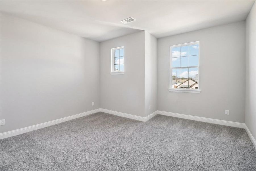 Spare room with plenty of natural light and carpet floors