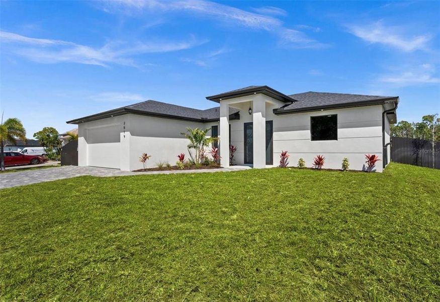 Front exterior of a new home in , Cape Coral, FL, highlighting curb appeal (Image 2). Front exterior of a new home in , Cape Coral, FL, highlighting curb appeal (Image 2).