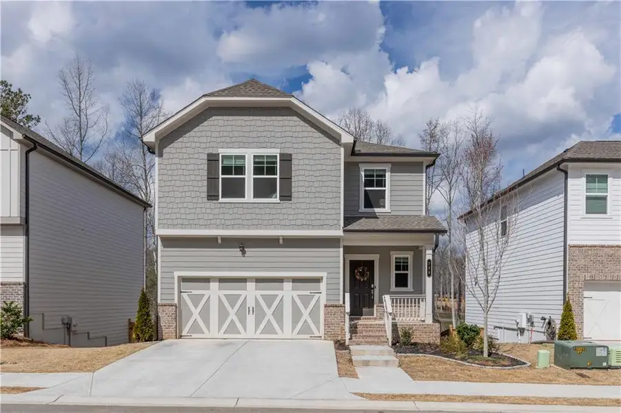 Front exterior of a new home in Creekside at Farmers Crossing, Ball Ground, GA, highlighting curb appeal (Image 2).