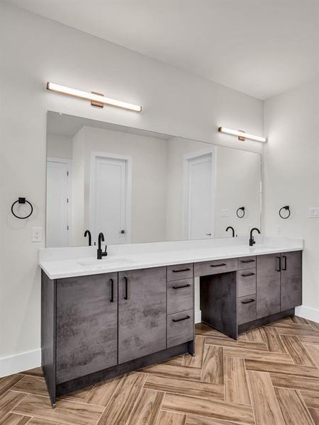 Bathroom featuring vanity and parquet floors