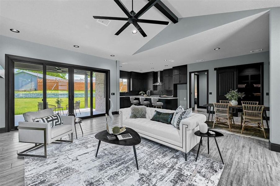 Living area featuring a ceiling fan, light wood-style flooring, and recessed lighting Living area featuring a ceiling fan, light wood-style flooring, and recessed lighting