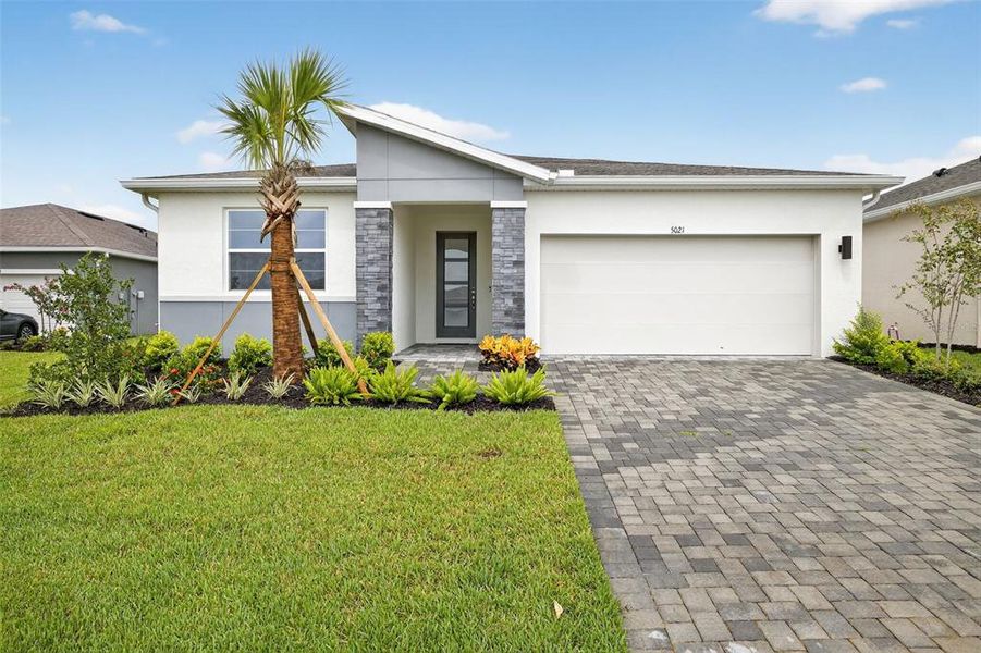 Front exterior of a new home in Windwater, Parrish, FL, highlighting curb appeal (Image 18).