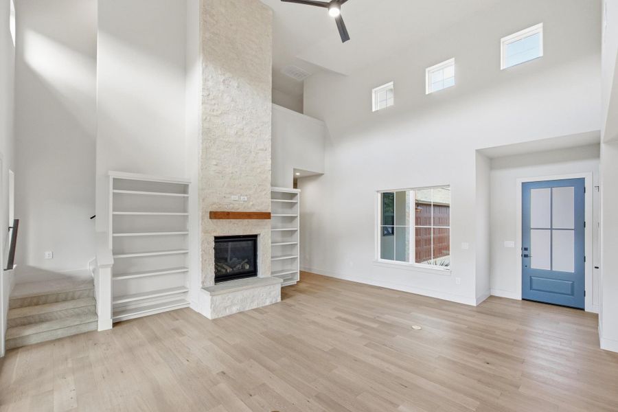Light filled family room with limestone fireplace and clerestory windows