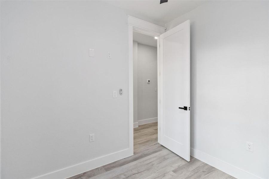 Unfurnished room featuring baseboards and light wood finished floors