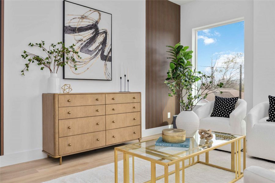 This photo showcases a bright, modern living space featuring warm wood accents, contemporary furniture, and natural greenery for a clean, inviting aesthetic.