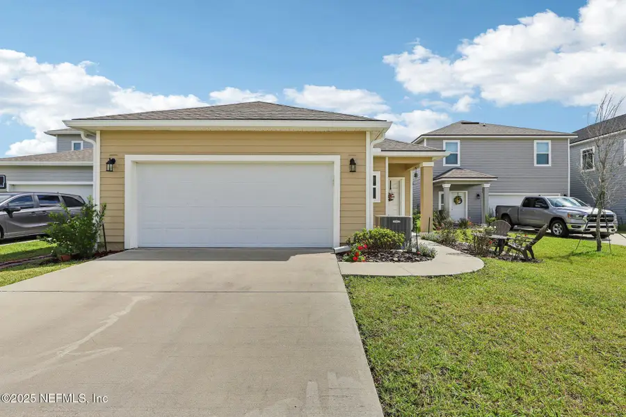 Front exterior of a new home in Tributary, Yulee, FL, highlighting curb appeal (Image 2). Front exterior of a new home in Tributary, Yulee, FL, highlighting curb appeal (Image 2).