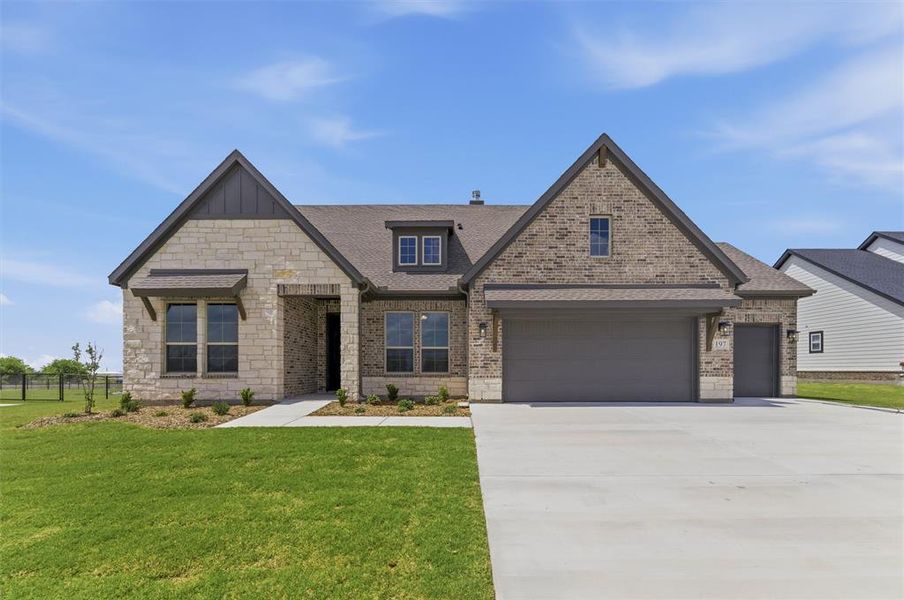 View of front of home featuring driveway, a shingled roof, stone siding, and brick siding View of front of home featuring driveway, a shingled roof, stone siding, and brick siding