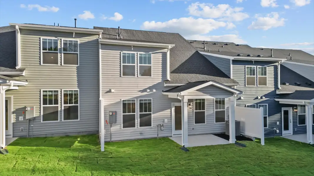 Rear covered porch creates a seamless extension of this home’s elegant design