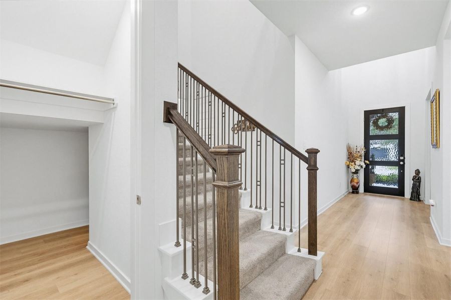 The entryway hall features a charming staircase leading to the second floor, along with a spacious under stair closet, offering both style and smart storage right at the entrance.