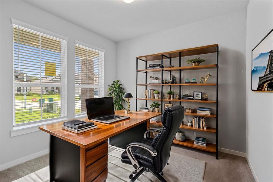 Quietly nestled in front of the home is the handsome home office. Featuring plush carpet flooring, high ceilings, large windows with privacy blinds and custom paint.