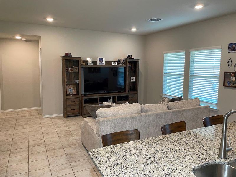 Living room featuring light tile patterned floors and recessed lighting