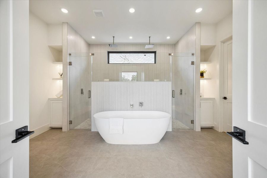 Luxurious bath with soaking tub, dual showers, and modern tile finishes. Luxurious bath with soaking tub, dual showers, and modern tile finishes.