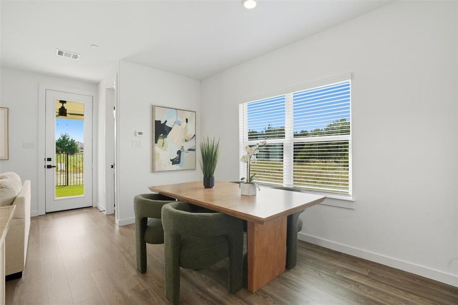 Home office with dark wood-style floors and recessed lighting
