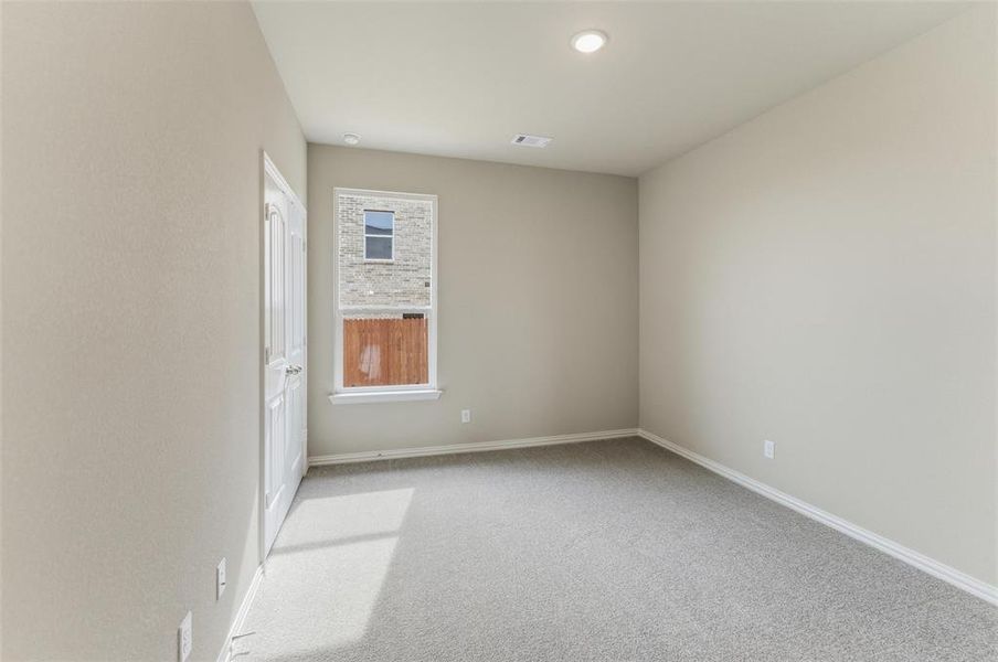 Unfurnished room featuring light colored carpet and baseboards