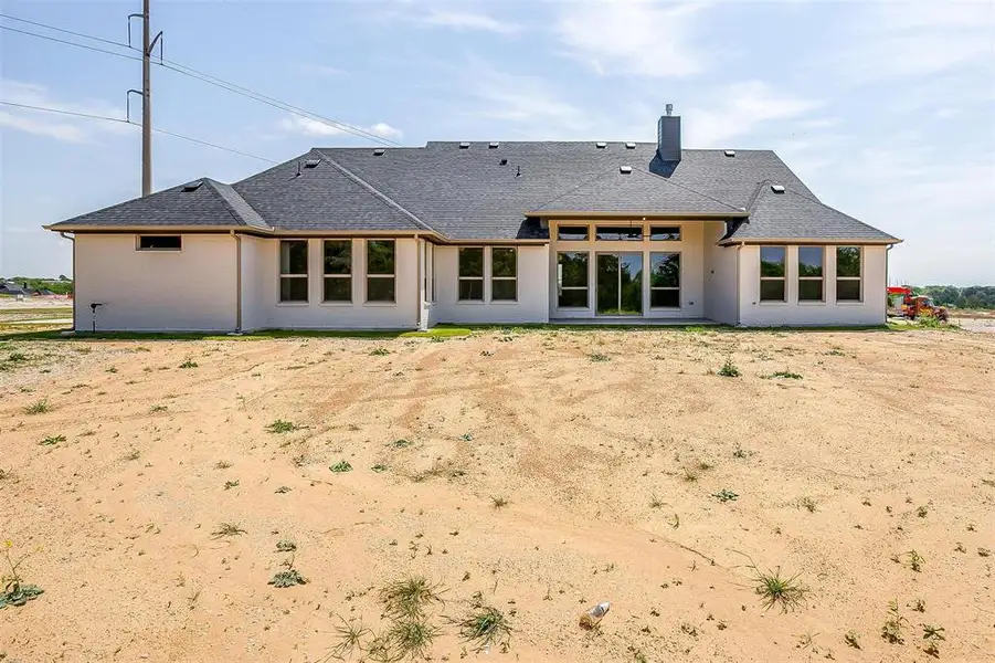 Rear view of property with a chimney and roof with shingles