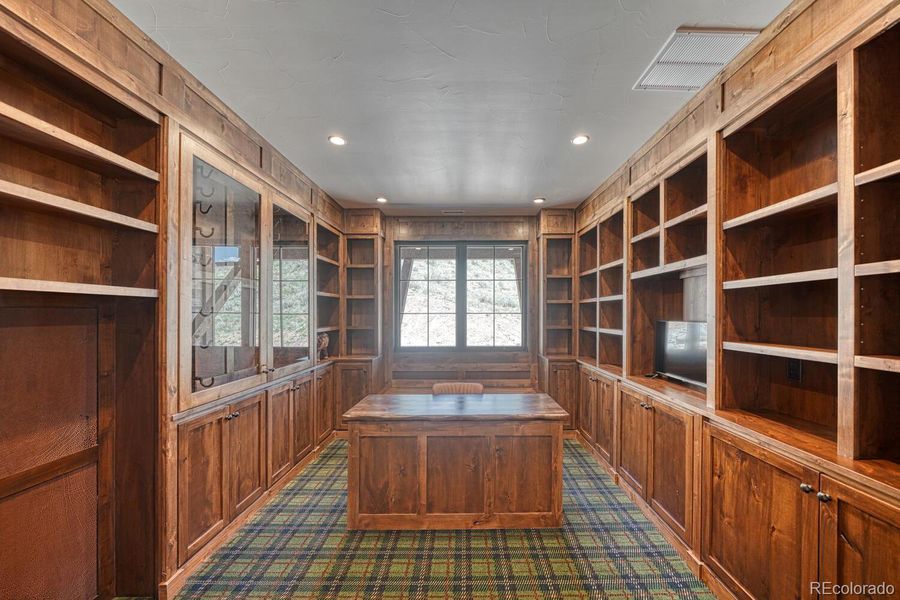 The private library features built in cabinets and carpet. The private library features built in cabinets and carpet.