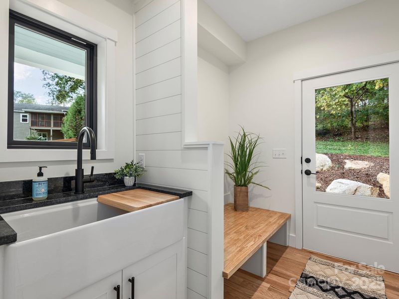 Tasteful and practical mud room with additional sink and storage