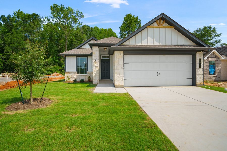 Front exterior of a new home in Highland Oaks, Tyler, TX, highlighting curb appeal (Image 1). Front exterior of a new home in Highland Oaks, Tyler, TX, highlighting curb appeal (Image 1).