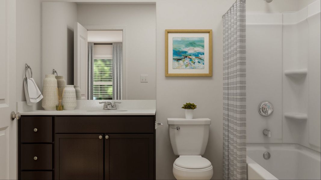 Ridgeland owners bathroom with vanity, toilet, and shower