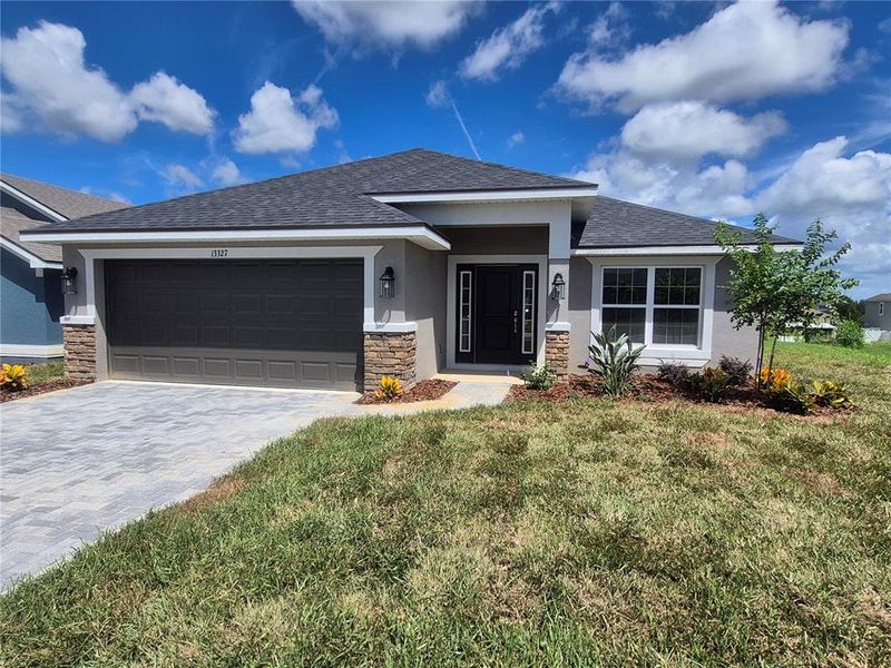 Front exterior of a new home in Abbey Glen, Dade City, FL, highlighting curb appeal (Image 17).