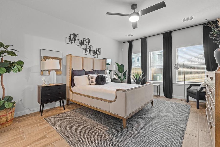 Your private primary sanctuary awaits this master bedroom combines elegance with tranquility. Primary suite located on the first floor. **This image is from another Saratoga Home with similar floor plan.