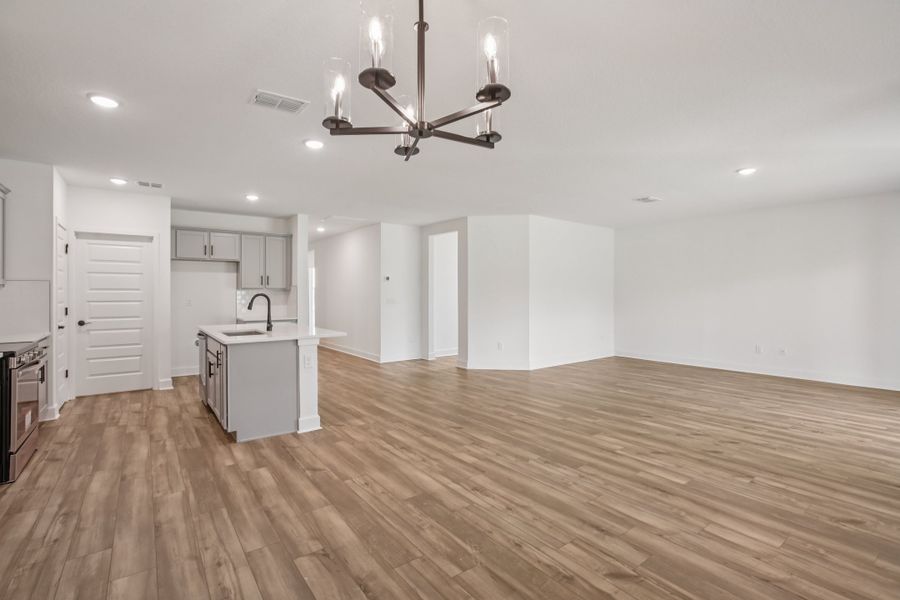 Experience luxury with wood flooring and modern gray cabinetry in the heart of Spring Hill's Deering II.