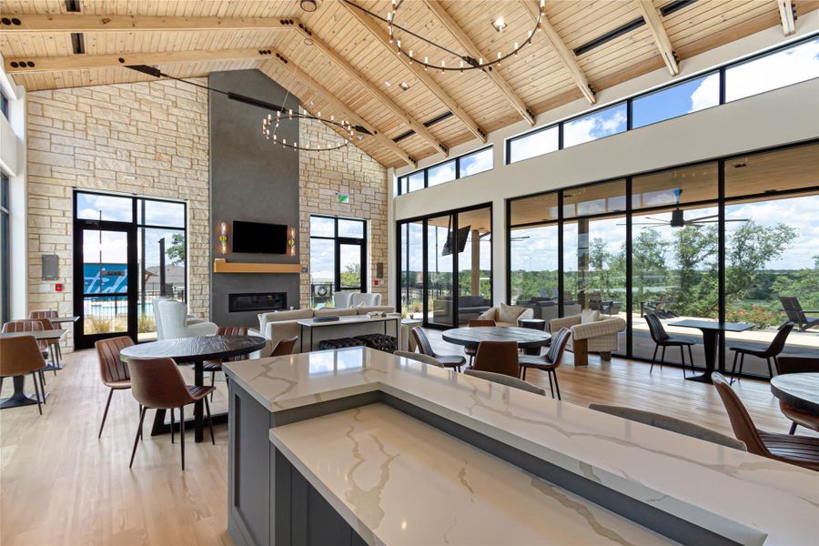 Kitchen featuring a high wood ceiling, light stone countertops, a large fireplace, open floor plan, and healthy amount of natural light