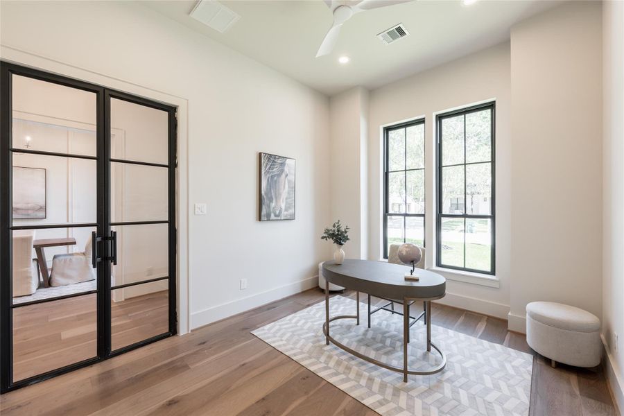 A versatile space designed with intention ideal for a home office, yet thoughtfully positioned to function as a private mother-in-law suite when needed that includes an ensuite.