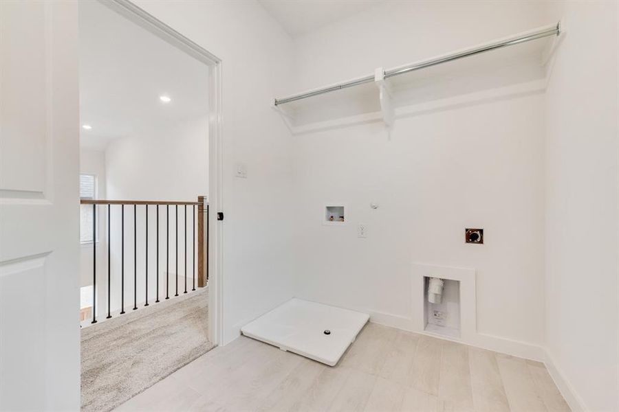 Laundry area featuring gas dryer hookup, electric dryer hookup, recessed lighting, washer hookup, and light carpet Laundry area featuring gas dryer hookup, electric dryer hookup, recessed lighting, washer hookup, and light carpet