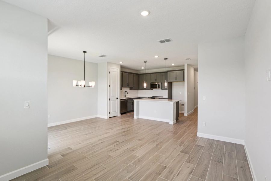 Open concept family room, dining room and kitchen -  Representative images and renderings are for illustrative purposes