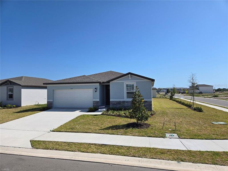 Front exterior of a new home in Magnolia Bay - Classic Series, Nokomis, FL, highlighting curb appeal (Image 16).